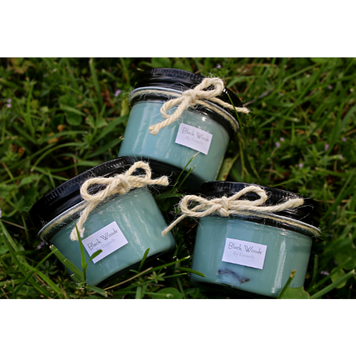 Three Black Woods Candles by Gravely Goods in grass